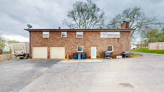 120 Gatone Dr, Hendersonville, TN 37075 - rear view of property with brick siding, aphalt driveway, fence, and a chimney