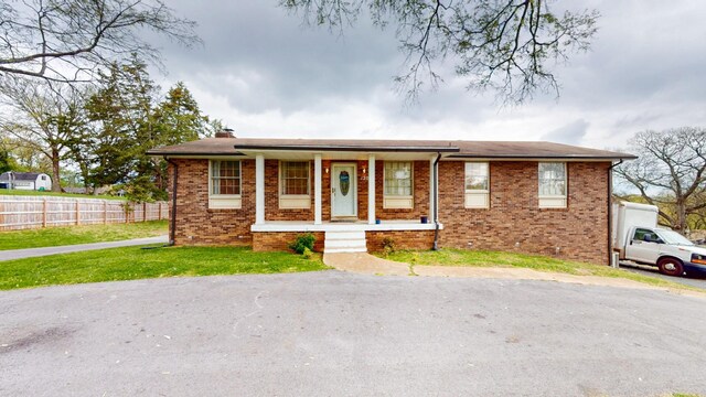 120 Gatone Dr, Hendersonville, TN 37075 - view of front of property with a front yard, covered porch, a chimney, fence, and brick siding