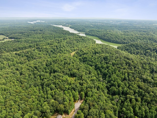 aerial view with a water view and a forest view