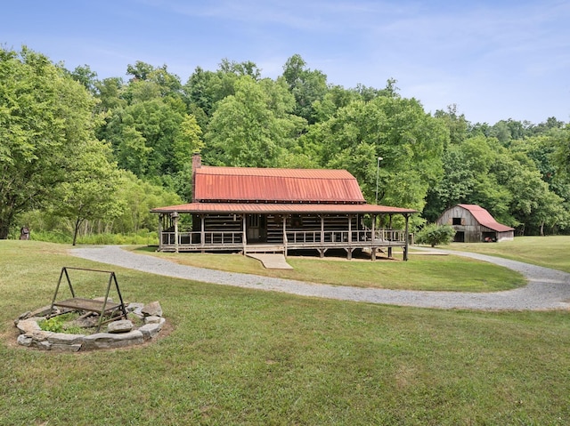 surrounding community with a lawn, an outbuilding, an outdoor fire pit, and a barn
