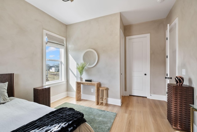 bedroom with baseboards and light wood-style flooring
