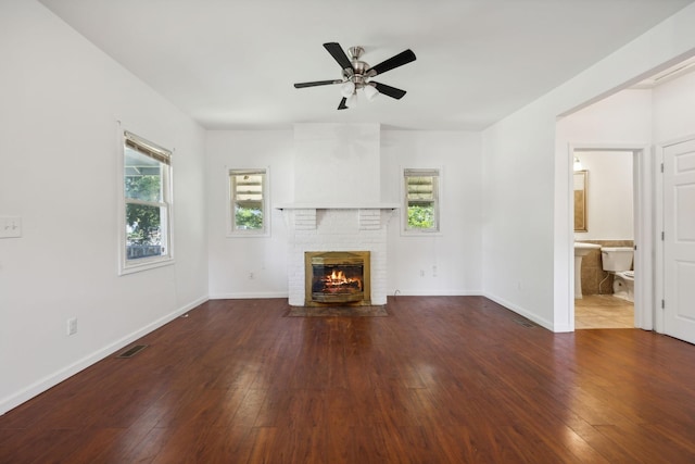 1902 Meridian St, Nashville, TN 37207 - unfurnished living room with wood-type flooring, ceiling fan, a fireplace, and visible vents
