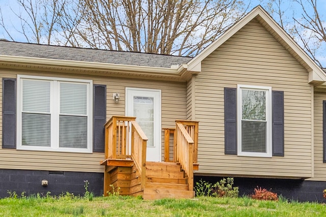 view of front of home featuring crawl space and roof with shingles