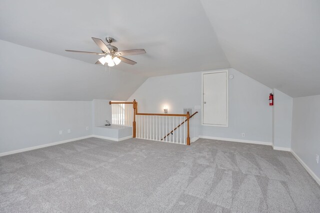 additional living space featuring a ceiling fan, carpet floors, baseboards, and lofted ceiling