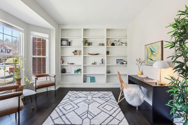 home office featuring baseboards, built in features, and dark wood-style flooring