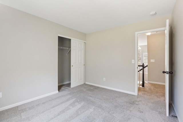 unfurnished bedroom featuring baseboards, a closet, and carpet flooring