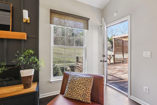 doorway with baseboards and wood finished floors