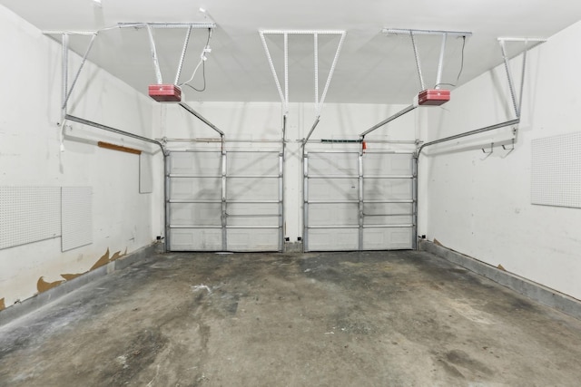 garage with baseboards and a garage door opener