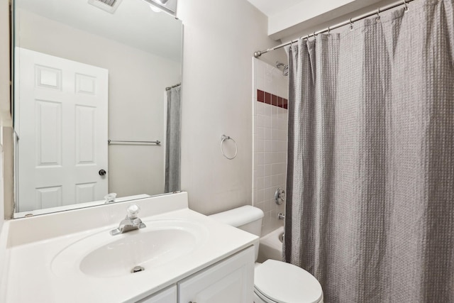 full bathroom with visible vents, toilet, shower / bath combo with shower curtain, and vanity