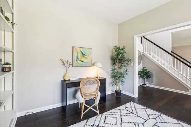 office area with baseboards, visible vents, and hardwood / wood-style floors