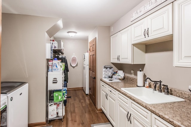 5267 Lickton Pike, Goodlettsville, TN 37072 - kitchen with light countertops, a sink, washer / dryer, white cabinets, and dark wood-style flooring