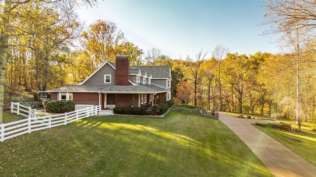 5267 Lickton Pike, Goodlettsville, TN 37072 - farmhouse inspired home featuring a chimney, a porch, fence, and a front lawn