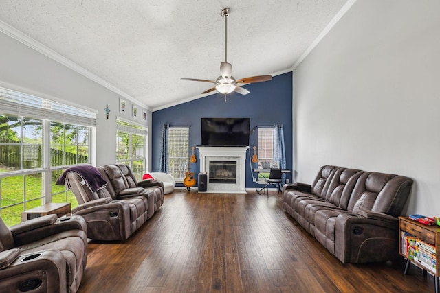 living room featuring ornamental molding, a ceiling fan, a high end fireplace, wood-type flooring, and lofted ceiling