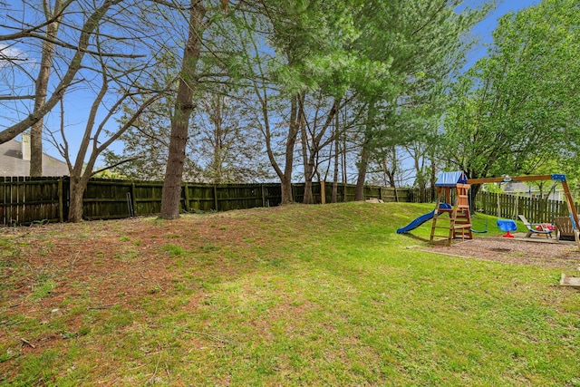 view of yard with a fenced backyard and a playground