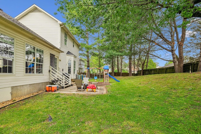 view of yard with fence and a playground