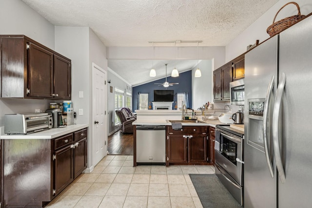 kitchen with a sink, light countertops, a ceiling fan, stainless steel appliances, and light tile patterned flooring