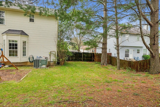 view of yard featuring central air condition unit and fence private yard