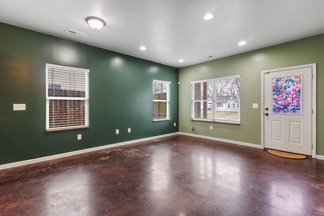 entryway with finished concrete flooring, baseboards, visible vents, and recessed lighting