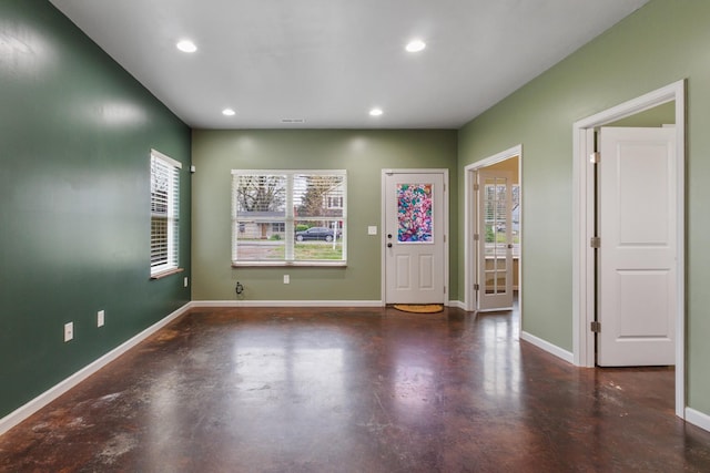 foyer entrance with baseboards, visible vents, recessed lighting, and finished concrete floors