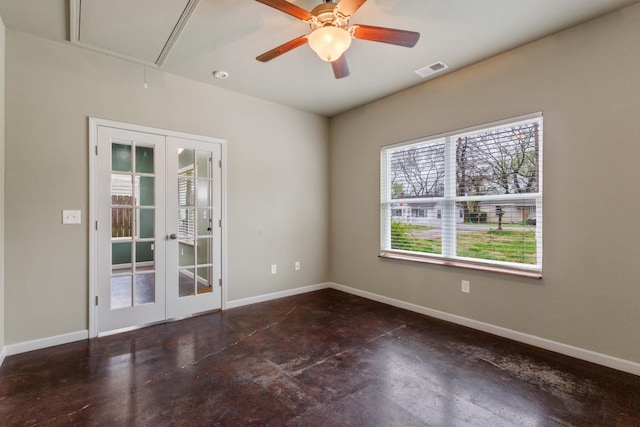 empty room with french doors, concrete floors, and attic access