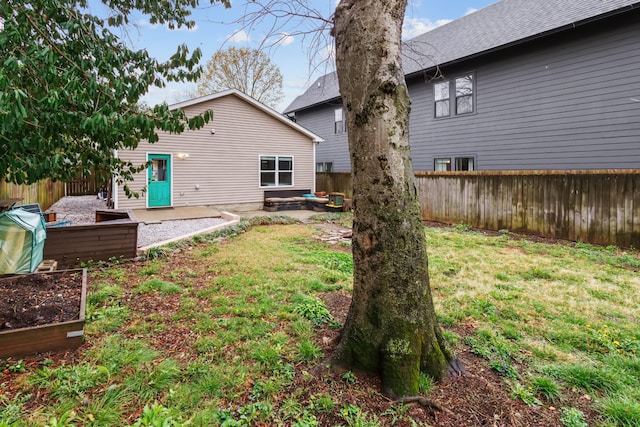view of yard featuring fence and a vegetable garden