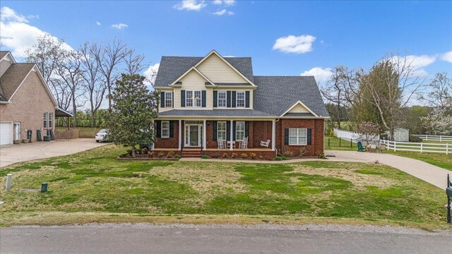 106 Irving Hills Ct, Lascassas, TN 37085 - view of front of house with fence, driveway, a front lawn, brick siding, and a porch