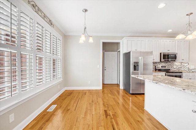 106 Irving Hills Ct, Lascassas, TN 37085 - kitchen featuring visible vents, a chandelier, crown molding, tasteful backsplash, and appliances with stainless steel finishes