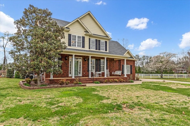 106 Irving Hills Ct, Lascassas, TN 37085 - view of front of house with roof with shingles, fence, a front yard, brick siding, and a porch