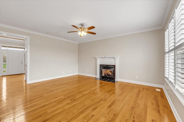 106 Irving Hills Ct, Lascassas, TN 37085 - unfurnished living room with ceiling fan, light wood-style flooring, a tiled fireplace, and crown molding
