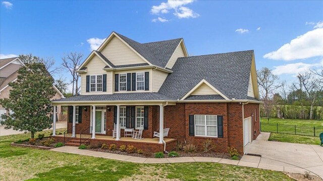 106 Irving Hills Ct, Lascassas, TN 37085 - view of front of house with fence, concrete driveway, a front yard, brick siding, and covered porch