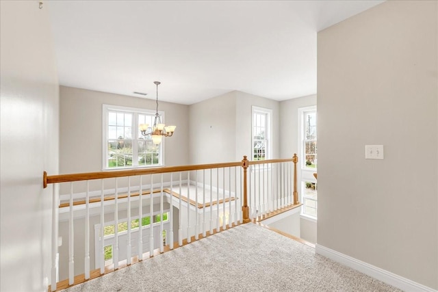 106 Irving Hills Ct, Lascassas, TN 37085 - hall featuring an upstairs landing, an inviting chandelier, carpet flooring, baseboards, and visible vents