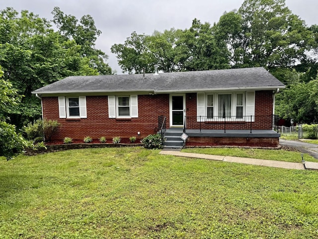 109 Preston Dr, Clarksville, TN 37042 - view of front of house with brick siding, a front lawn, covered porch, and a shingled roof