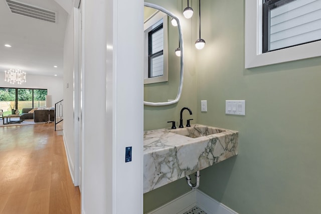 843B Dewees Ave, Nashville, TN 37204 - bathroom featuring visible vents, baseboards, wood finished floors, recessed lighting, and an inviting chandelier