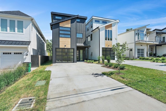 843B Dewees Ave, Nashville, TN 37204 - modern home with metal roof, a garage, a standing seam roof, board and batten siding, and driveway