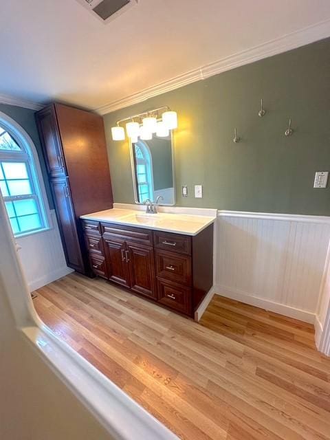 522 Norris Hancock, Big Rock, TN 37023 - bathroom with vanity, ornamental molding, visible vents, a wainscoted wall, and wood finished floors