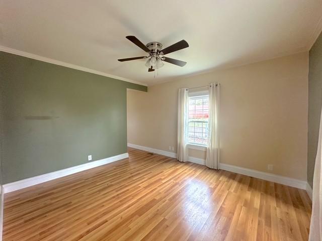 522 Norris Hancock, Big Rock, TN 37023 - spare room with light wood-style flooring, ornamental molding, baseboards, and a ceiling fan