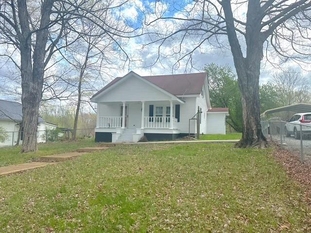 522 Norris Hancock, Big Rock, TN 37023 - bungalow featuring a carport, fence, a front lawn, and covered porch