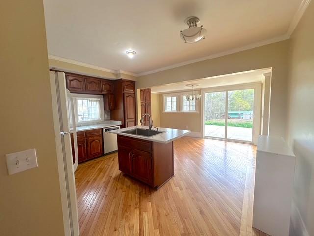 522 Norris Hancock, Big Rock, TN 37023 - kitchen featuring an inviting chandelier, dishwasher, a sink, light countertops, and light wood-type flooring