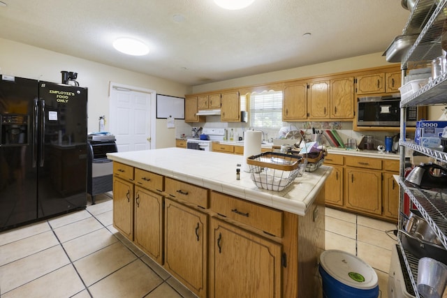 328 Cumberland St W, Cowan, TN 37318 - kitchen with black refrigerator with ice dispenser, electric range, under cabinet range hood, light tile patterned floors, and stainless steel microwave