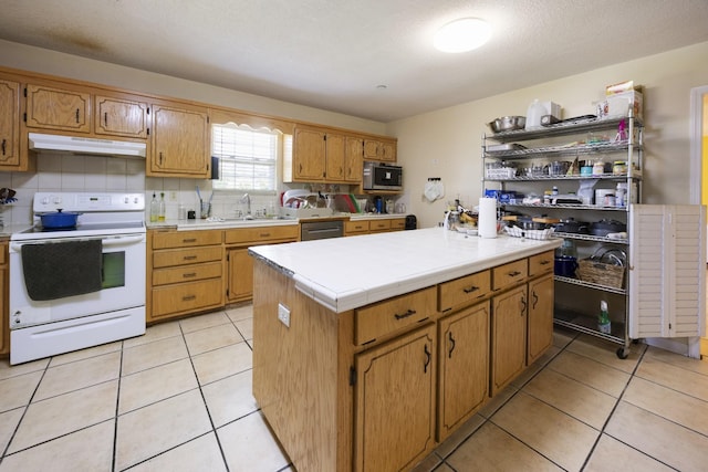 328 Cumberland St W, Cowan, TN 37318 - kitchen featuring stainless steel appliances, under cabinet range hood, tile countertops, light tile patterned floors, and a center island