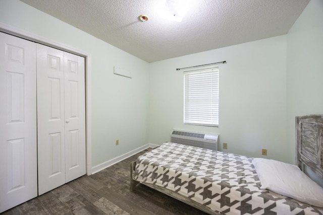 328 Cumberland St W, Cowan, TN 37318 - bedroom with wood finished floors, a wall unit AC, a textured ceiling, and a closet