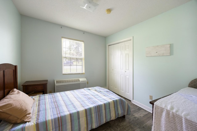 328 Cumberland St W, Cowan, TN 37318 - bedroom with dark wood-style flooring, a wall mounted air conditioner, and a closet