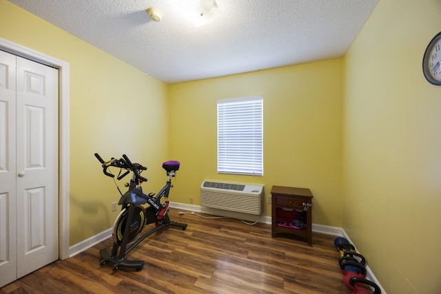 328 Cumberland St W, Cowan, TN 37318 - exercise room with wood finished floors, a textured ceiling, and a wall mounted AC