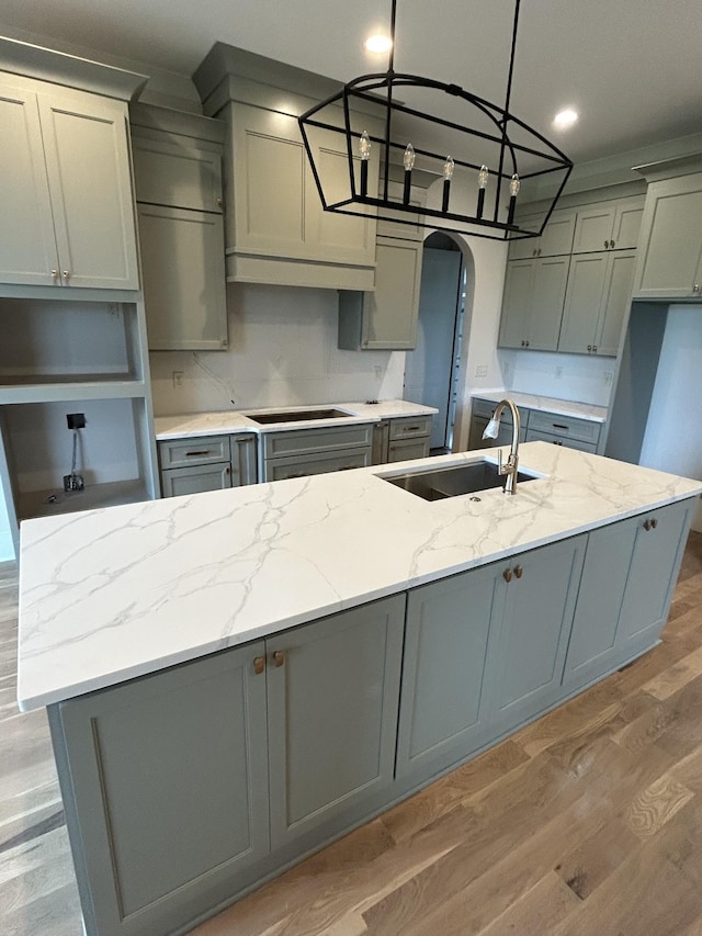 4613 Pat Nixon Ct, Murfreesboro, TN 37130 - kitchen featuring a sink, gray cabinetry, light wood-style floors, black electric cooktop, and light stone counters