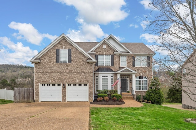 877 Loretta Dr, Goodlettsville, TN 37072 - view of front of home featuring a front lawn, driveway, fence, a garage, and brick siding