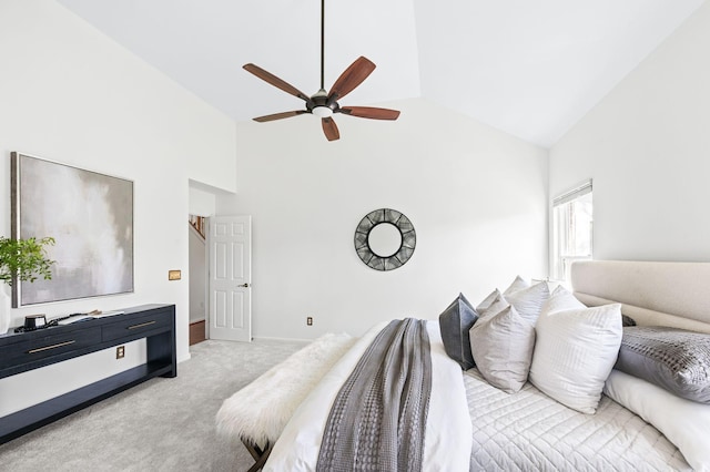 carpeted bedroom with high vaulted ceiling and ceiling fan