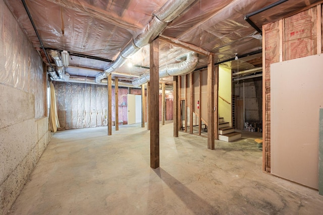 unfinished basement featuring stairs