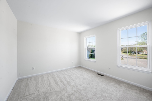 carpeted spare room with baseboards