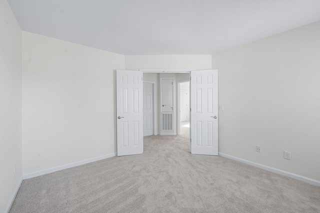 spare room with carpet and baseboards