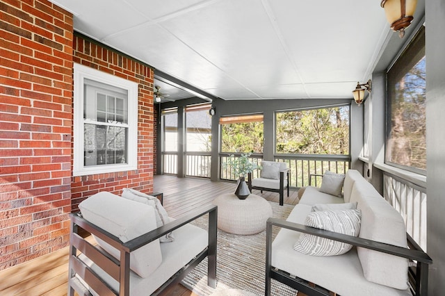 sunroom featuring outdoor lounge area